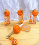 Lip Gloss Laranja com Chaveiro Love Rain - Brilho Espelhado, Hidratação e Aroma Frutal